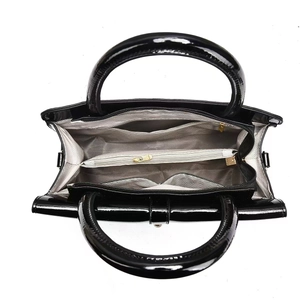 Detail view of the multi-compartment interior layout with herringbone lining and golden zipper