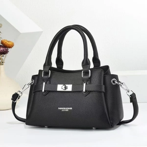 Detail of black litchi grain leather tote with silver lock and adjustable shoulder strap