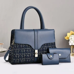 Detailed close-up of 3-piece navy blue tweed handbag set with gold clasp hardware