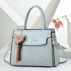 Light blue faux leather handbag with diamond quilting and plush bear charm decoration