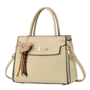 Beige faux leather handbag with V-shaped texture, gold lock, and plush bear charm