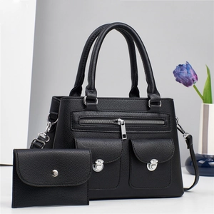 Black lychee textured tote bag set with silver hardware and front zipper pocket detail