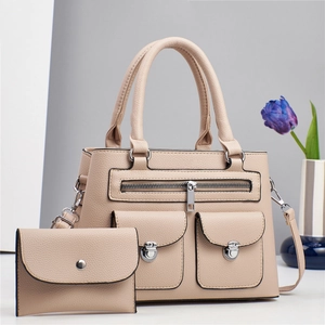 Detail of beige lychee grain leather tote bag set with matching envelope pouch