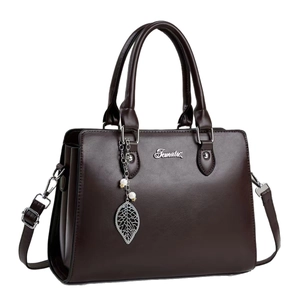 Elegant dark brown leather tote bag with dual handles and pearl leaf pendant on white background