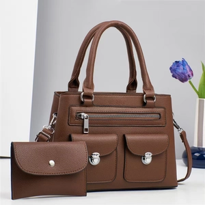 Brown lychee textured leather tote bag set with silver hardware and front zipper pockets