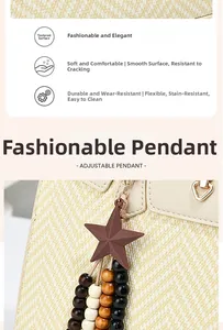 Detail of a stylish bag charm with wooden beads and a star on a woven straw handbag