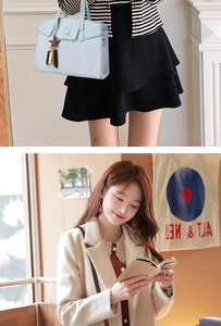 Detailed view of light blue tote bag featuring dual-textured weave and star charm