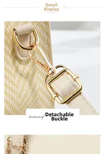 Close-up of woven beige texture with golden carabiner and leather strap details