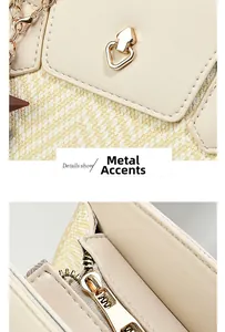 Close-up of beige contrast handbag featuring golden hardware arrow lock and smooth zipper