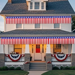 Patriotic red white and blue fringe banner and bunting on a white porch fence