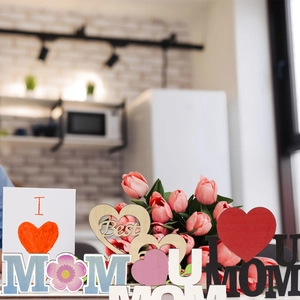 Detail of Mother's Day wooden MOM signs and heart card for table decoration