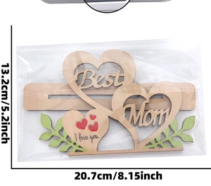 Detail of interlocking wooden hearts with Best Mom and I love you engraving for decor