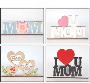 Detail of laser-cut Mother's Day wooden plaques with floral and heart-shaped patterns