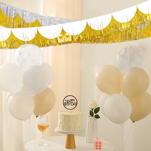 Detail of metallic gold and silver fringe banner for elegant birthday party backdrop