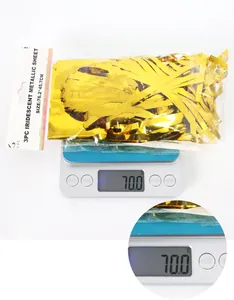 Weight display of 3-pack gold metallic foil fringe curtains in packaging showing 70g