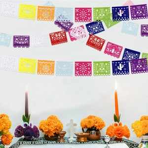 Macro detail of Mexican Papel Picado banner with Viva Mexico text and cactus patterns