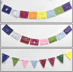 Detail of colorful Mexican felt banners with festive hollow patterns and VIVA MEXICO text