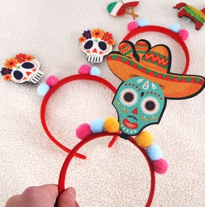 Detail of Day of the Dead headbands with skull motifs and colorful pom-poms decor