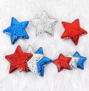 Close-up of red silver and blue glitter star hair clips in assorted sizes for 4th of July