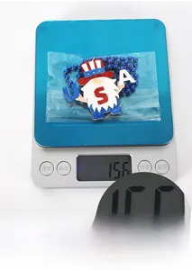 Weight measurement of a USA patriot gnome pendant with glitter and blue bead chain