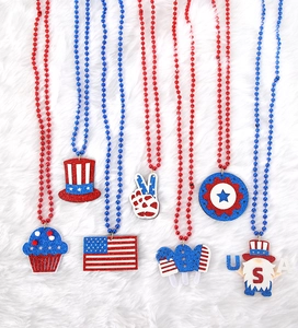 Macro view of July 4th necklaces featuring patriotic pendants like flags and stars