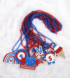 Detail of glitter patriotic pendants with stars and gnomes on red and blue beaded necklaces