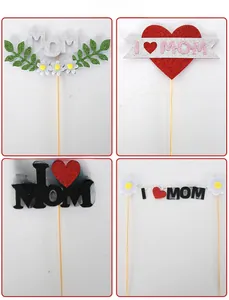 Detailed views of four Mother's Day glitter cake toppers with MOM and heart designs
