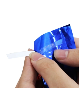 Detail of glossy metallic blue foil table skirt showing the white self-adhesive sealing strip