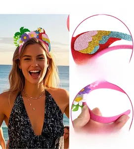 Macro detail of tropical glitter parrot and monstera leaf on an elastic party headband