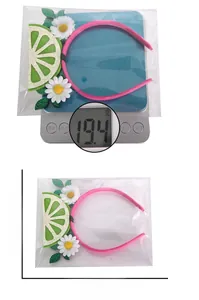 Pink headband detail with white daisies and lemon accents showing dimensions and weight