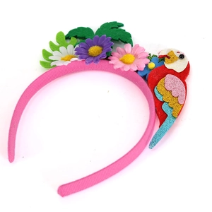 Pink fabric headband with felt flowers and a colorful parrot decoration for summer parties