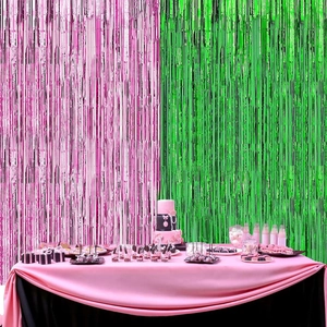 Pink and green tinsel foil fringe curtains displayed behind a festive dessert table setup