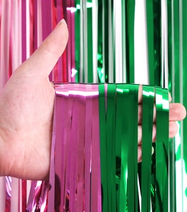 Close-up of metallic pink and green tinsel foil curtains for party decorations