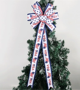 Close-up of USA patriotic bow with stars and stripes on a snowy Christmas tree