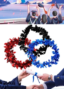 Detail of multi-colored graduation tinsel garland with mortarboard cap shape sequins