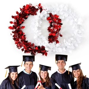 Detail of red and white graduation garlands with shiny foil leaves and party scene