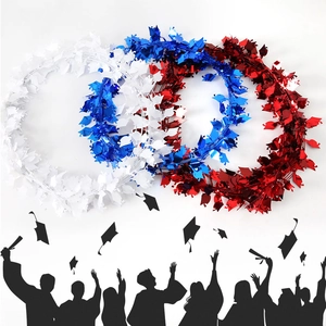 Macro detail of red, white, and blue graduation tinsel garland with mini mortarboard charms