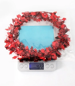 Close-up of red graduation tinsel garland with mortarboard shapes on a digital scale