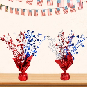 Red, silver, and blue 4th of July star tinsel fountain centerpieces on a wood surface