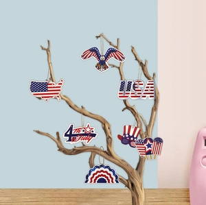 Detail of wooden 4th of July ornaments with eagle and flag hanging on branches
