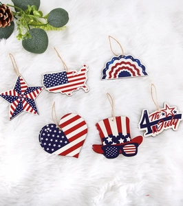 Detailed flat lay of wooden July 4th ornaments on white plush background