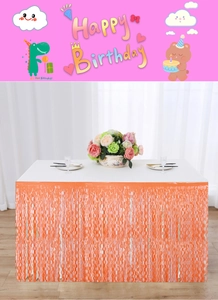 Detail of orange metallic fringe table skirt with reflective wavy texture for party decor