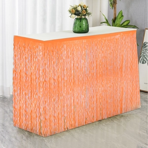 Vibrant orange macaron foil fringe table skirt with wave tassels for birthday party decor