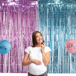 Blue and purple foil fringe curtains with Boy or Girl gender reveal party balloons