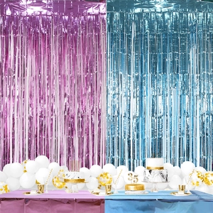 Close-up of pink and blue fringe curtains with matching tablecloth for gender reveal party
