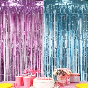 Blue and pink metallic fringe curtains for gender reveal party backdrop decorations