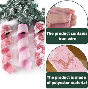Close-up of pink Christmas burlap ribbons with wire edges and reindeer patterns