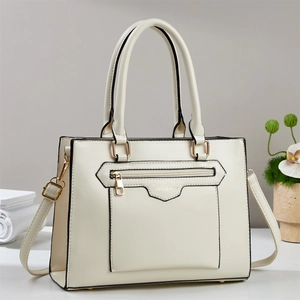 Cream vintage tote bag with stone texture, gold zipper, and adjustable shoulder strap