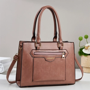 Detail of vintage stone texture tote bag with golden hardware and adjustable strap