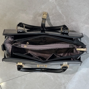 Interior view of crocodile embossed tote bag with multiple compartments and gold zipper